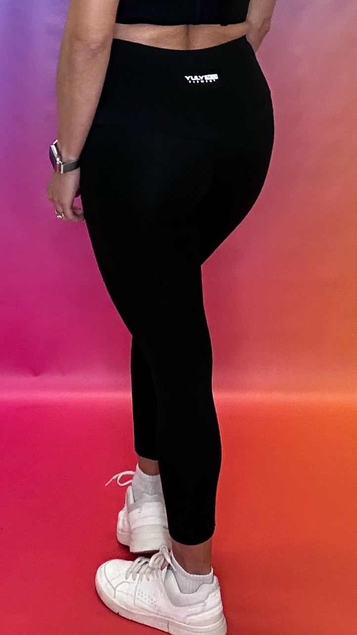 Side profile in black Chase Leggings, showing sculpting compression