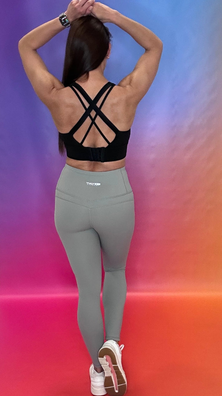 Back view in grey Chase Leggings showing supportive waistband and crisscross detail