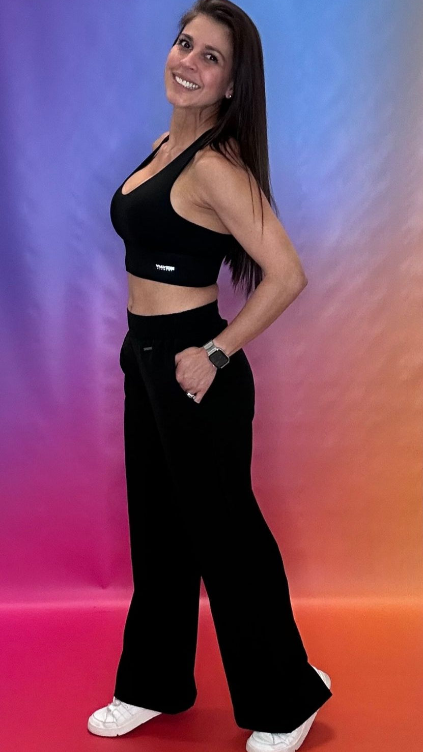Wide-leg high-waisted palazzo pants styled with a bright sports bra from YULY360