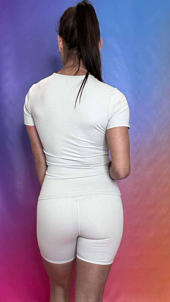 Back view of Trek T-shirt in beige — relaxed fit performance activewear