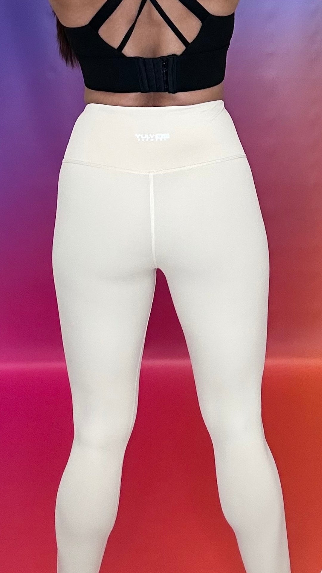 Back view of high-rise Emerge Legging in beige with YULY360 logo