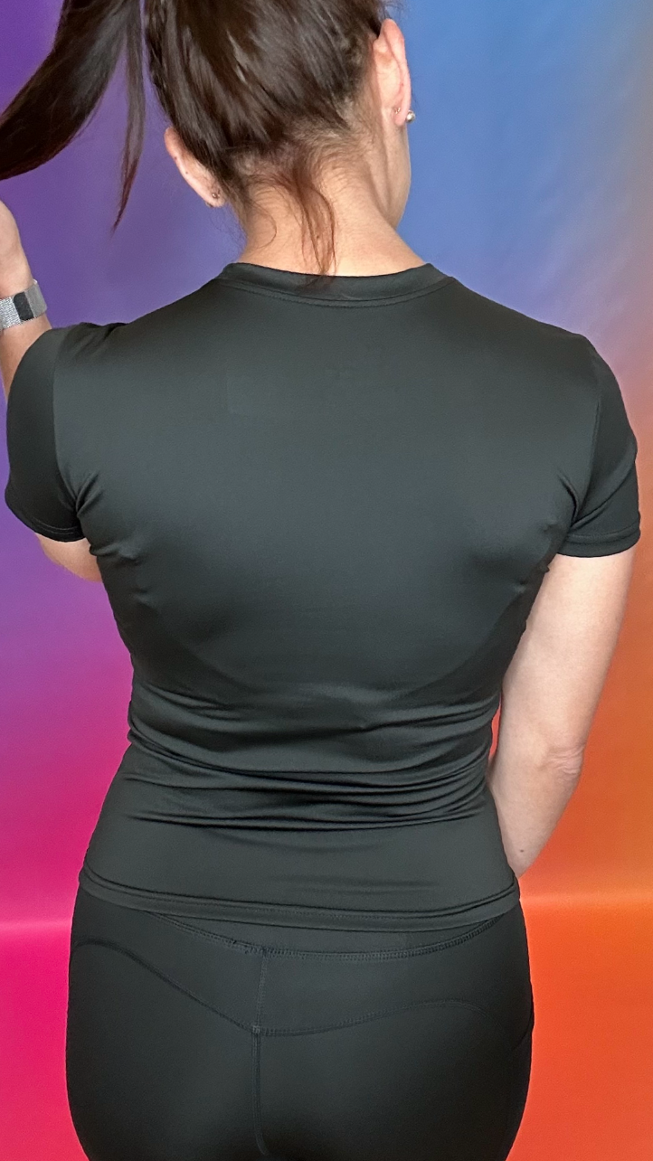 Back view of Summit Shirt in black — flattering body-contouring seams