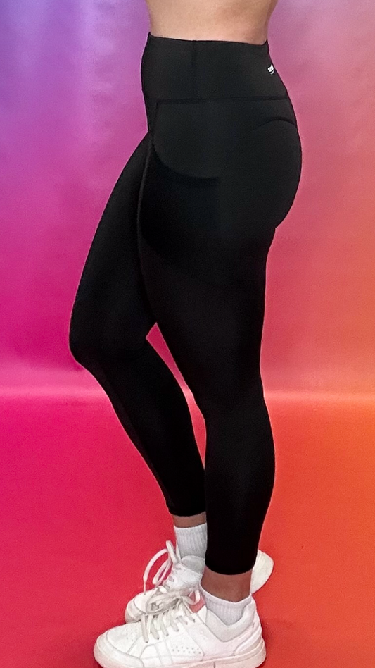Side profile of Synergy Leggings in black — contour seams and deep pockets