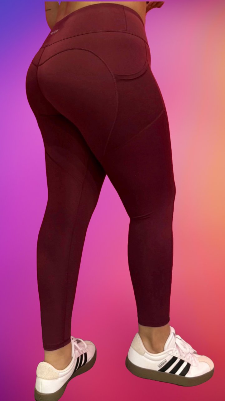 Side profile of Synergy Leggings in burgundy — flattering compression seams