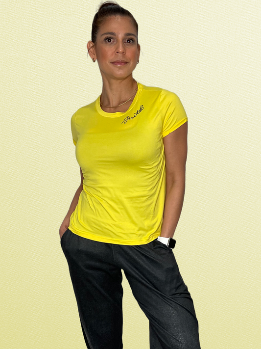 Front view of Faith yellow YULY360 activewear top paired with black joggers